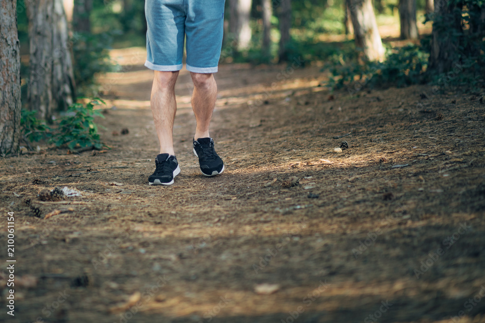 Detail of Men's Feet Running in Park