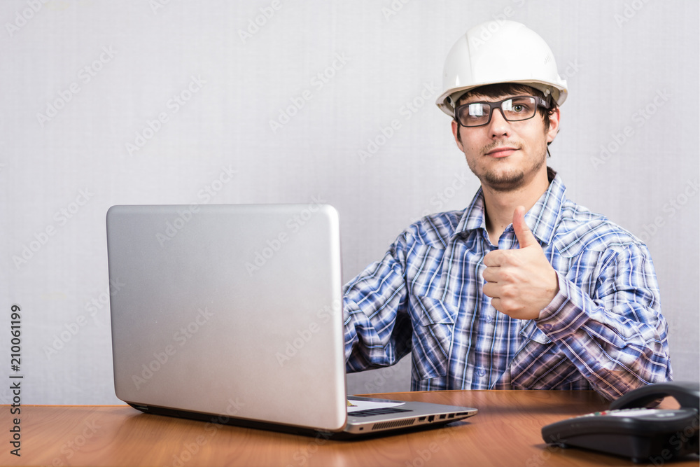 a young guy in a white helmet sitting at the table a young guy in a white helmet sitting at the table
