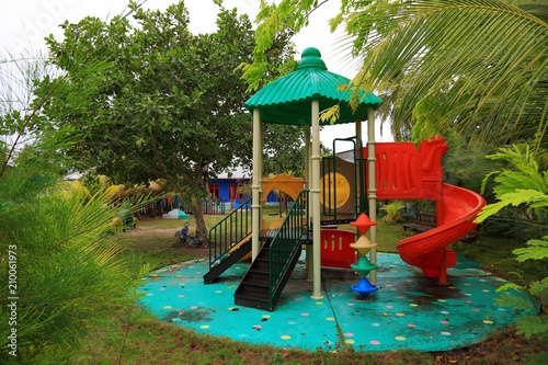 Close up view of outdoor children playground activity place on local Maldive island Danghethi. Green trees on background.