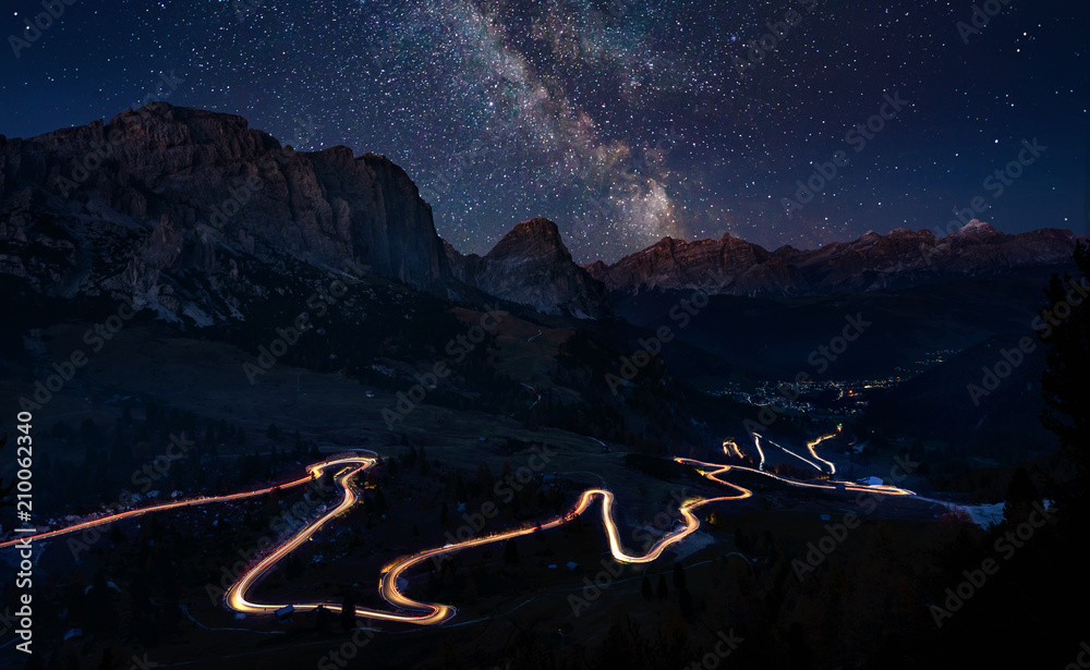 Traffic trails on mountain pass at night with milkyway - obrazy, fototapety, plakaty 