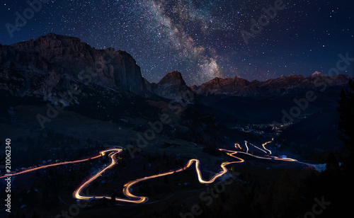 Traffic trails on mountain pass at night with milkyway photo