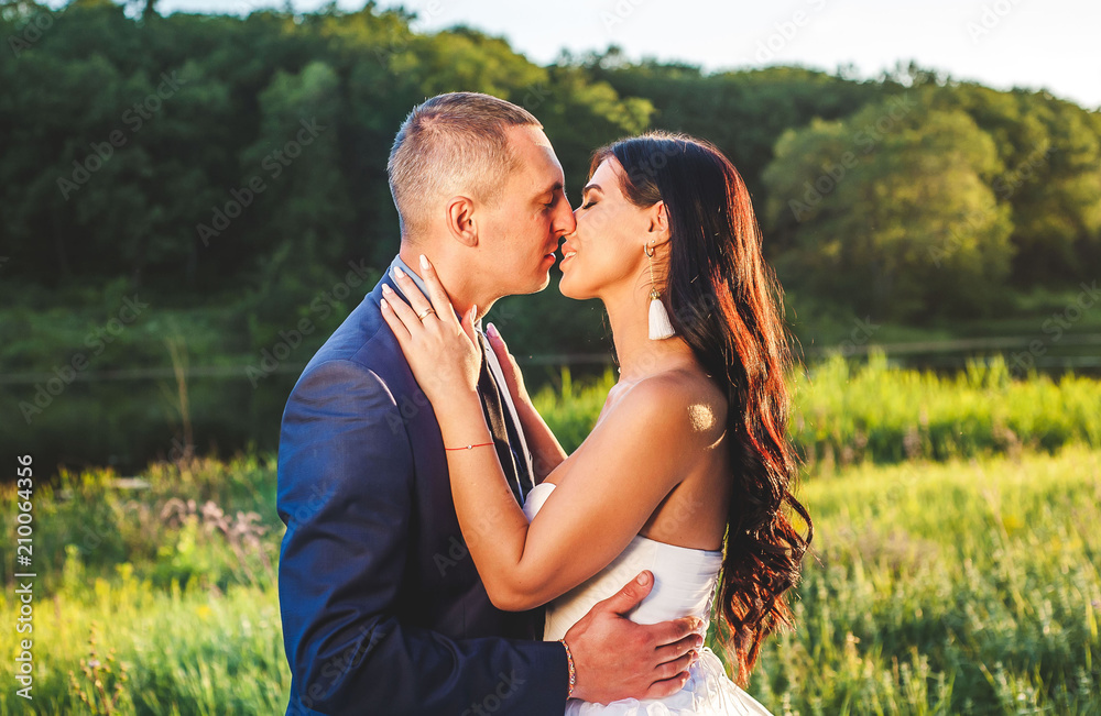 bride and groom on their wedding day, nature walks, kiss and hugs, sunset bride and groom on their wedding day, nature walks, kiss and hugs, sunset