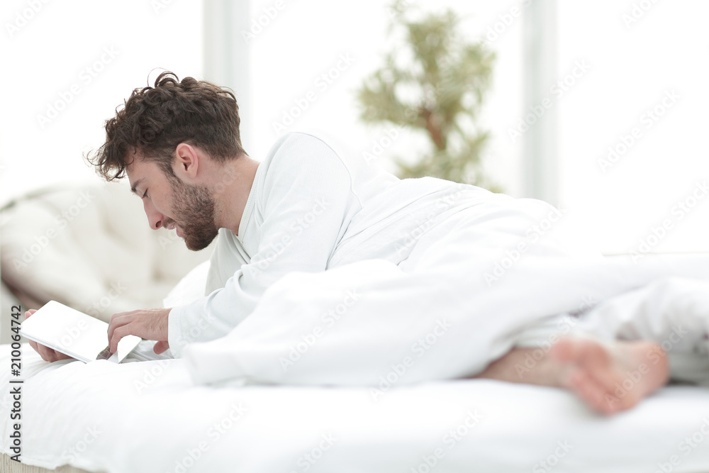 closeup.awakened man typing with a digital tablet closeup.awakened man typing with a digital tablet