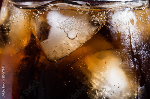 Cola with ice cubes in a close-up glass
