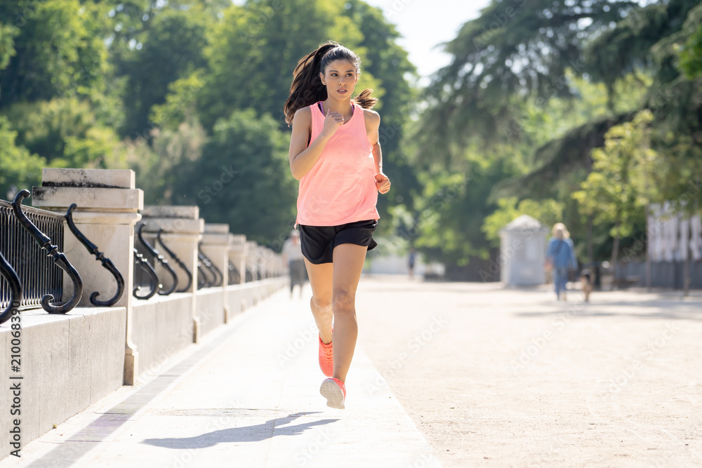 young pretty runner working out in a green city park in exercise fitness concept young pretty runner working out in a green city park in exercise fitness concept