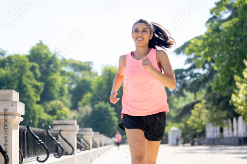 young attractive happy runner working out in a city party in fitness concept
