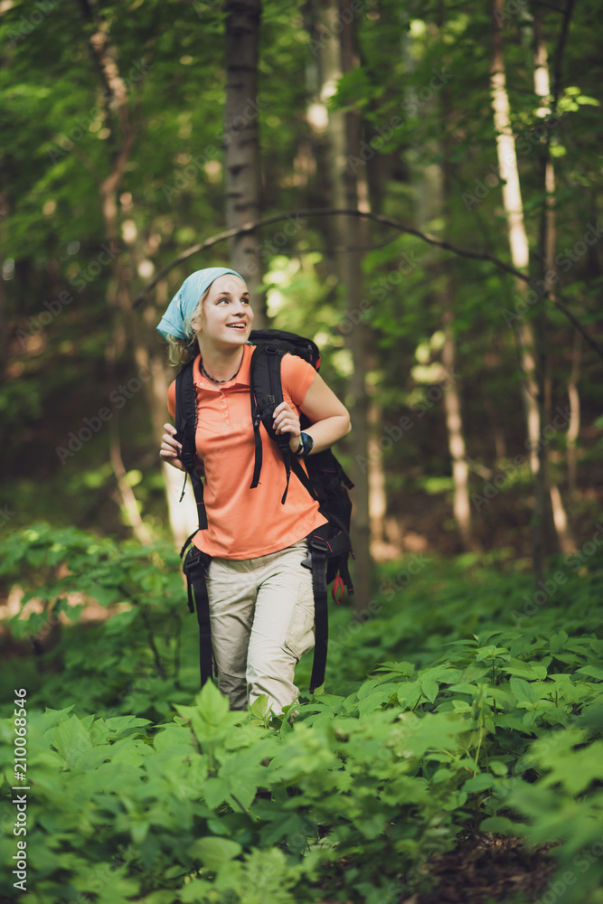 girl tourist with a backpack traveling in the forest girl tourist with a backpack traveling in the forest