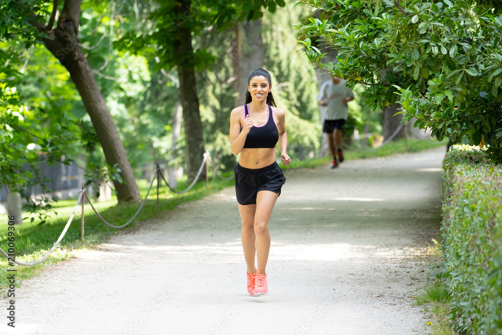 young attractive happy runner working out in a city party in fitness concept young attractive happy runner working out in a city party in fitness concept