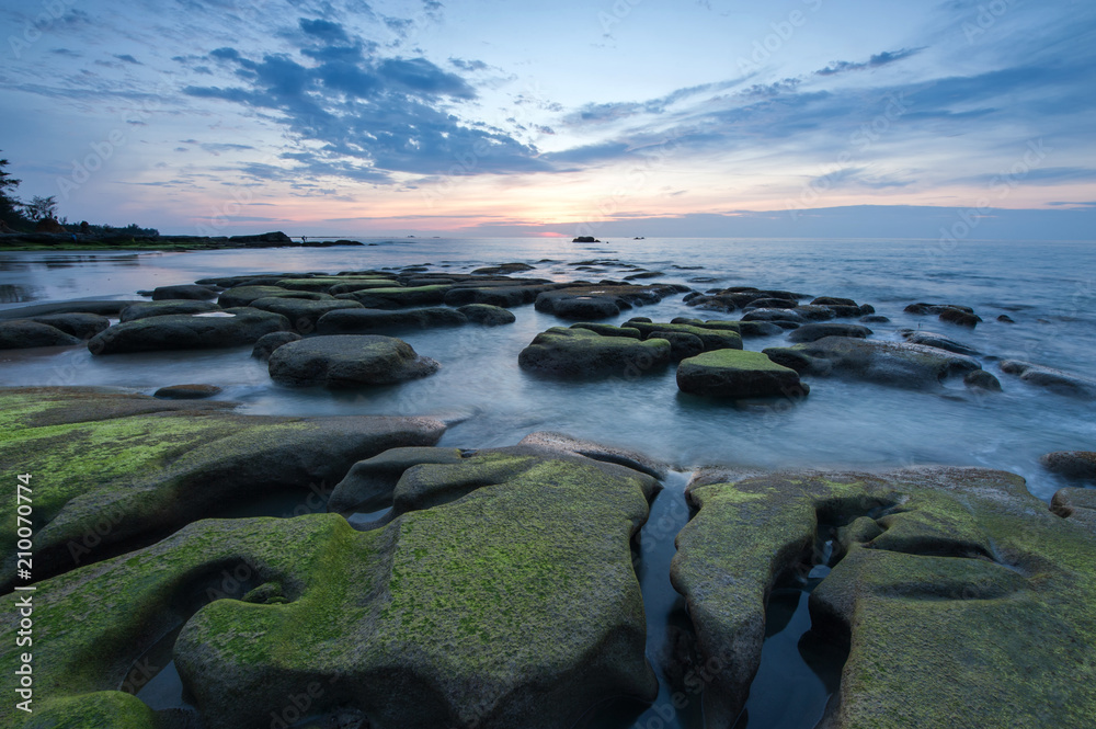 Beautiful sunset seascape with natural coastal rocks. 