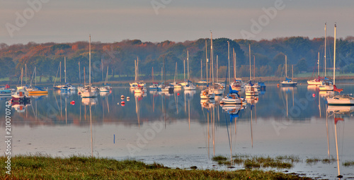 Yachts moored in Chichester Harbour at Apuldram, (Fishbourne Channel), West Sussex, England, UK. photo