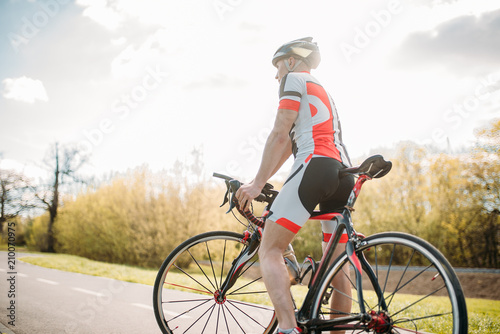 Fototapeta Naklejka Na Ścianę i Meble -  Bycyclist in helmet and sportswear on bike workout