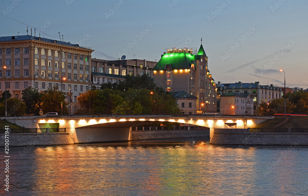 Fototapeta premium Bridge and building with a green roof in the evening. Russia, Moscow, June 2018