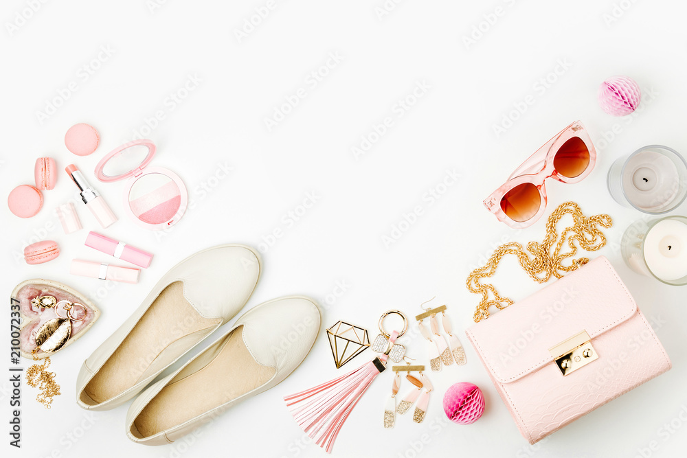 Fototapeta premium Flat lay of female fashion accessories, shoes, makeup products and handbag on pastel color background. Beauty and fashion concept