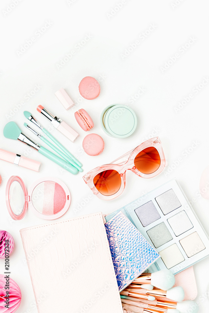 Flat lay of female fashion accessories, shoes, makeup products and handbag on pastel color background. Beauty and fashion concept