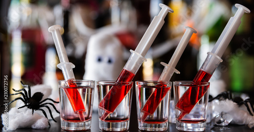 Tablou pe pânză creepy halloween party cocktails with syringes of grenadine syrup as blood, shot