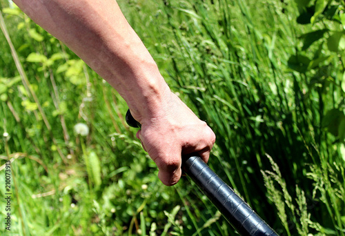 a man's hand is very tense holding a stick