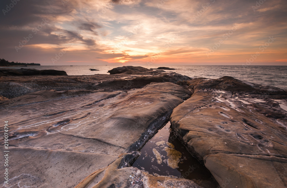 natural coastal rocks during beautiful sunset.