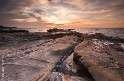 natural coastal rocks during beautiful sunset.