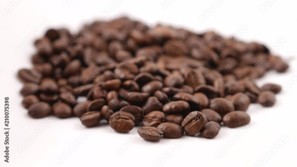 Coffee beans on the white surface Coffee beans on the white surface