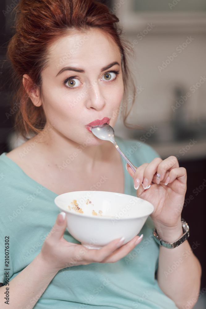 Beautiful pregnant woman eating cereals Beautiful pregnant woman eating cereals