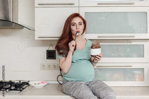  Pregnant woman enjoying eating chocolate