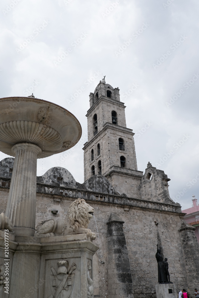 Looking at the belfry from behind the lion fountain of the Convento de San Francisco de Asís (Convent of San Francisco of Asis) in the Plaza of San Francisco in Old Town Havana, Cuba.