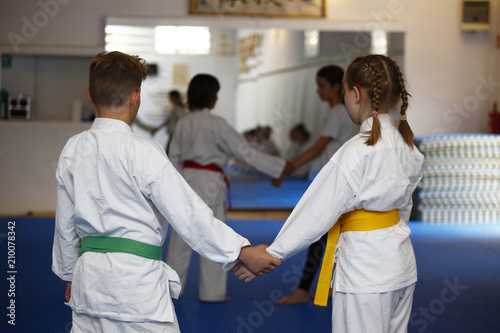 Children in kimono during aikido training in the gym