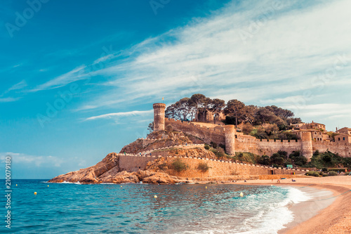 Sea landscape Badia bay in Tossa de Mar in Girona, Catalonia, Spain near of Barcelona. Ancient medieval castle with nice sand beach and clear blue water. Famous tourist destination in Costa Brava photo