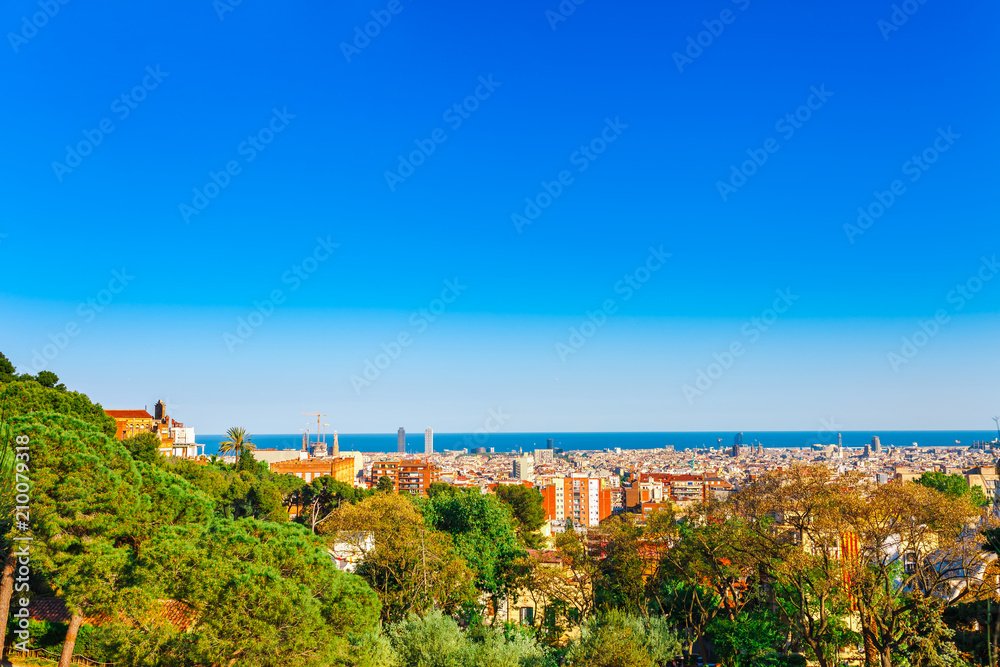 Skyline landscape of beautiful Barcelona from the Guel park in a clear blue sky and sunny day. Famous tourist destination Catalonia, Spain