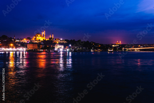 Night view of Istanbul. Panorama cityscape of famous tourist destination Golden Horn bay part of Bosphorus strait. Travel illuminated landscape Bosporus, Turkey, Europe and Asia.