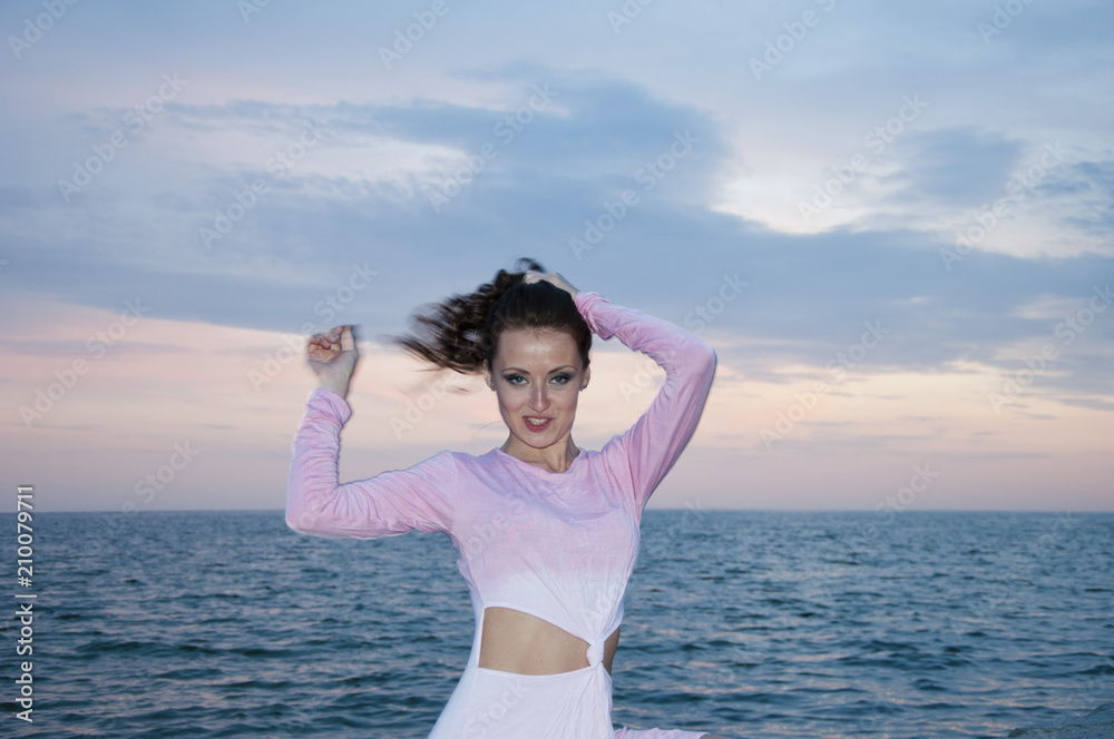 free and happy. woman on sunset sky background in summer near sea. summer vacation and traveling. fashion look of brunette woman. sexy girl in pink dress at sea water. ecology and environment. beach free and happy. woman on sunset sky background in summer near sea. summer vacation and traveling. fashion look of brunette woman. sexy girl in pink dress at sea water. ecology and environment. beach