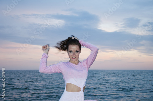 free and happy. woman on sunset sky background in summer near sea. summer vacation and traveling. fashion look of brunette woman. sexy girl in pink dress at sea water. ecology and environment. beach