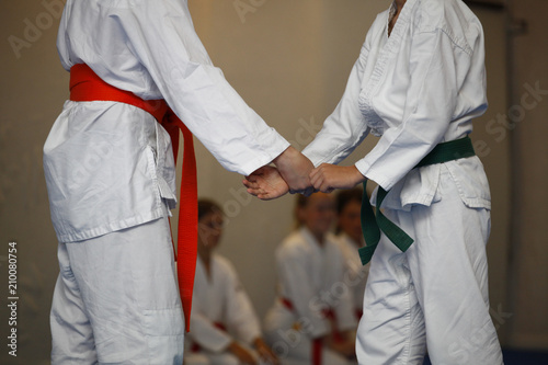 Children in a white kimono during an exercise aikido in the gym