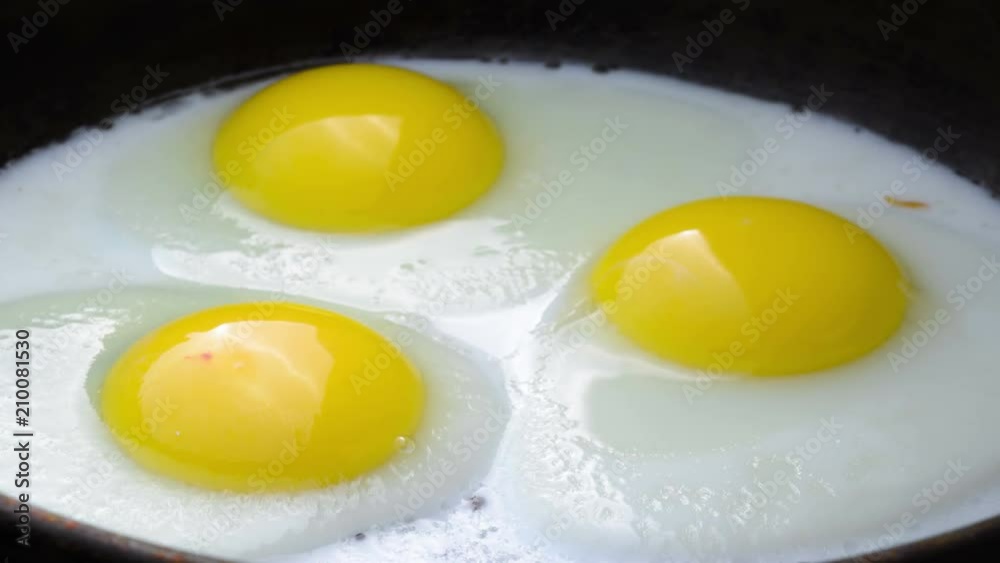 Cooking Fried eggs. Process of Preparation of Three Fried Egg. Time Lapse. Cooking Fried eggs. Process of Preparation of Three Fried Egg. Time Lapse.