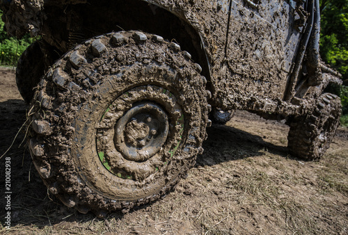 Wheels of off road car stuck full of mud 