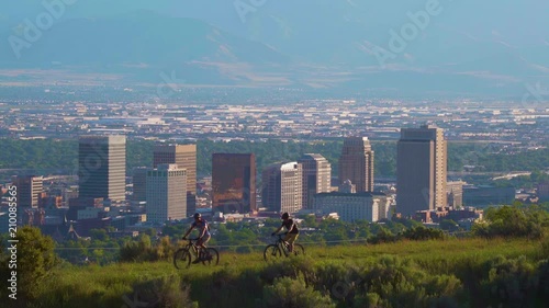 Salt Lake City Skyline with mountain bikers passing by