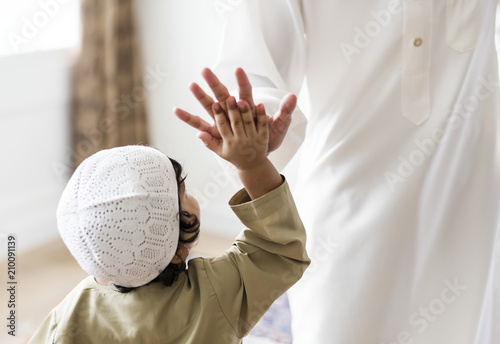 Muslim boy giving a high five photo