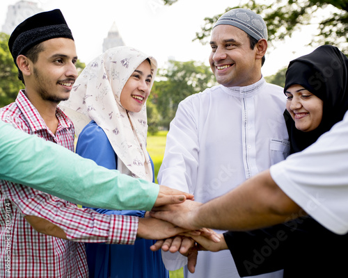 Muslim group of friends stacking hands photo