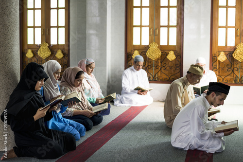 Muslims reading from the quran photo