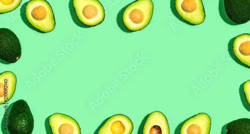 Fresh avocado pattern on a green background flat lay