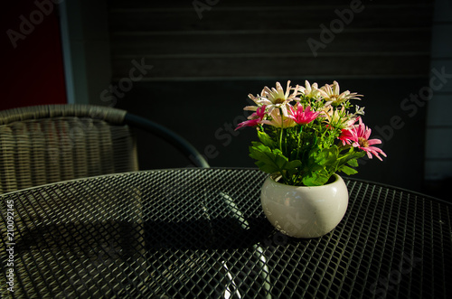 Flowers in a vase are placed on the table.