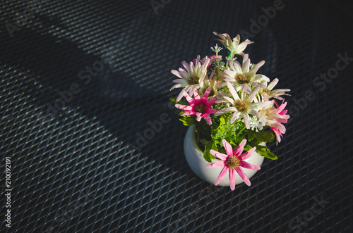 Flowers in a vase are placed on the table.