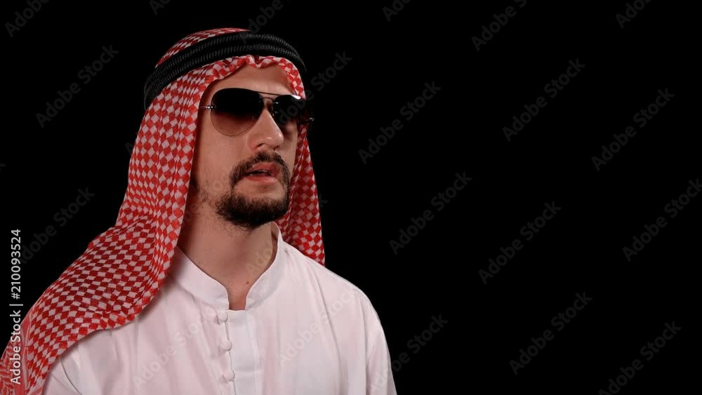 Arab in national costume raises a leaf with the inscription of the country Ukraine Arab in national costume raises a leaf with the inscription of the country Ukraine