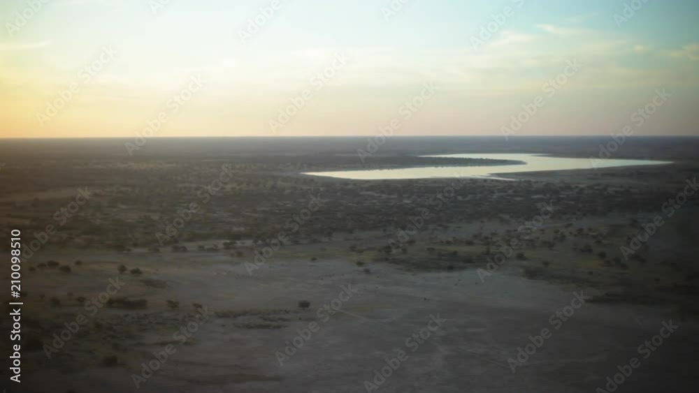 A wide shot of a grayish land and sky with river A wide shot of a grayish land and sky with river