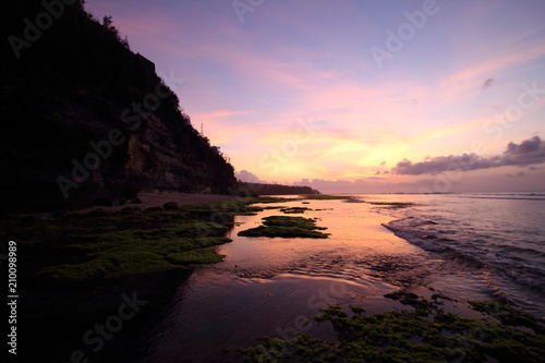 Magenta purple sunset colors reflected in tide pools