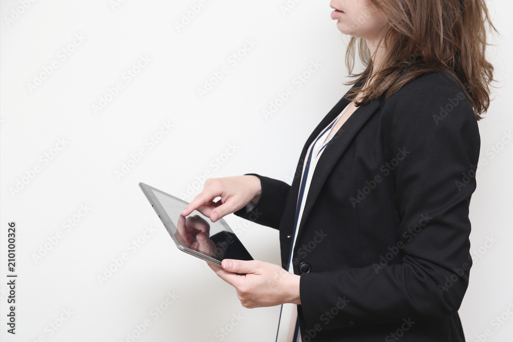 Close up of business woman in a work day. Holding a tablet. Close up of business woman in a work day. Holding a tablet.