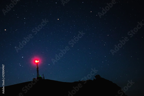 Tower and starry sky in the mountains, Base station. photo