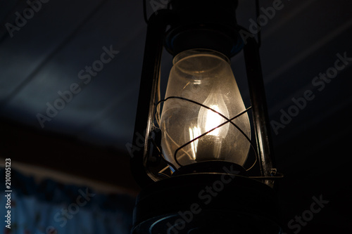 The dull light of a kerosene lamp
