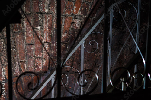 Ray of light in an ancient brick temple behind a wrought-iron lattice