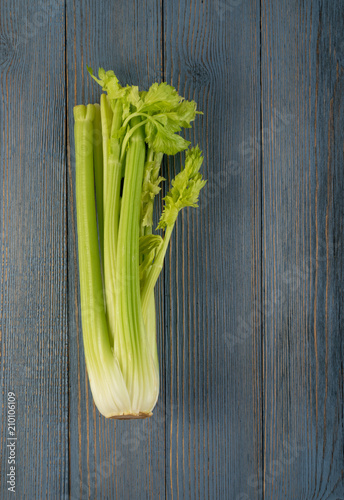 Celery stalks on wood background